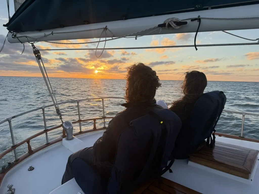 Couple watching sunset from the bow
