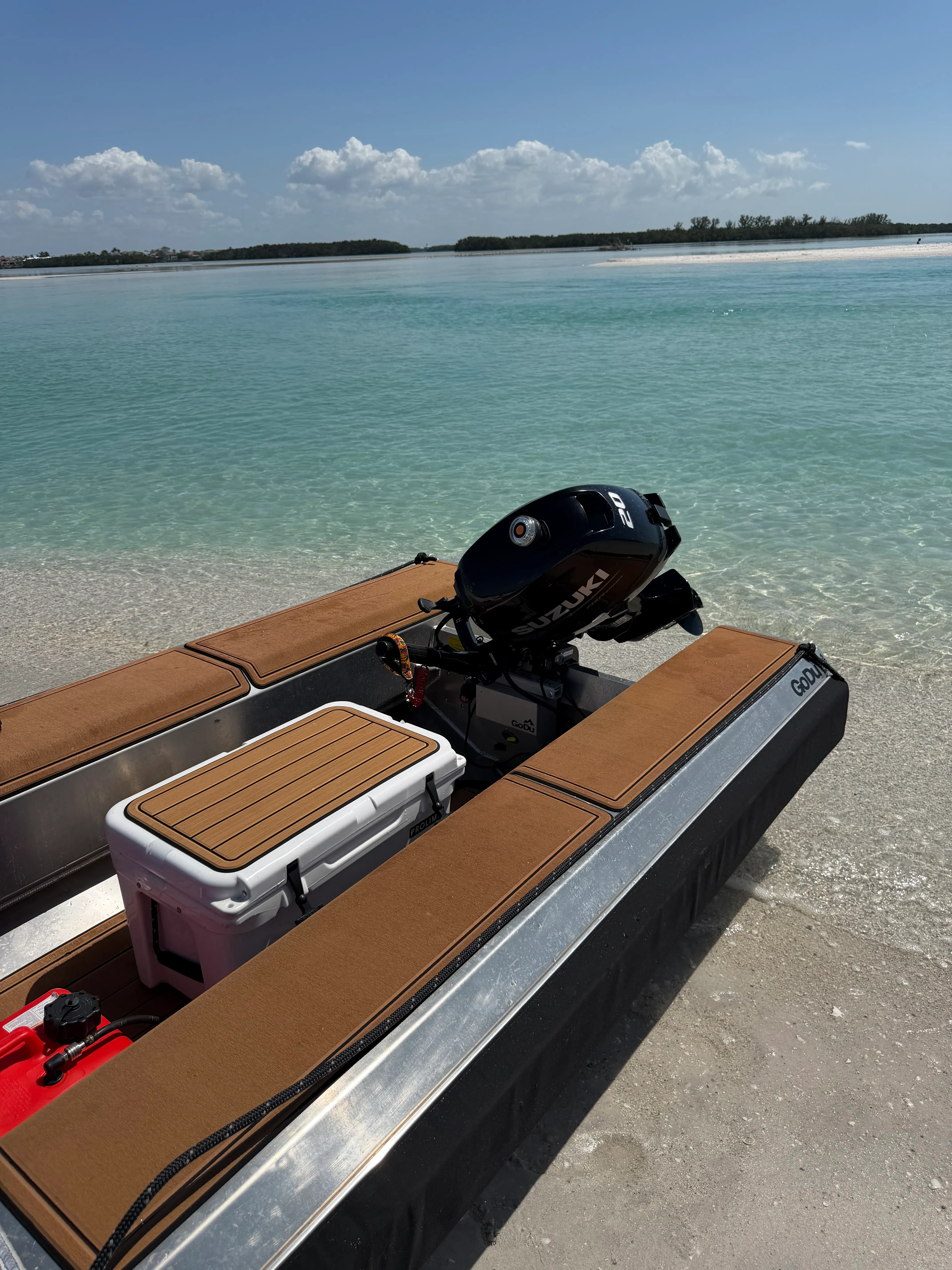 GoDu dinghy on the sandbar with cooler, ready to shuttle guests ashore from S/V Cay Michele