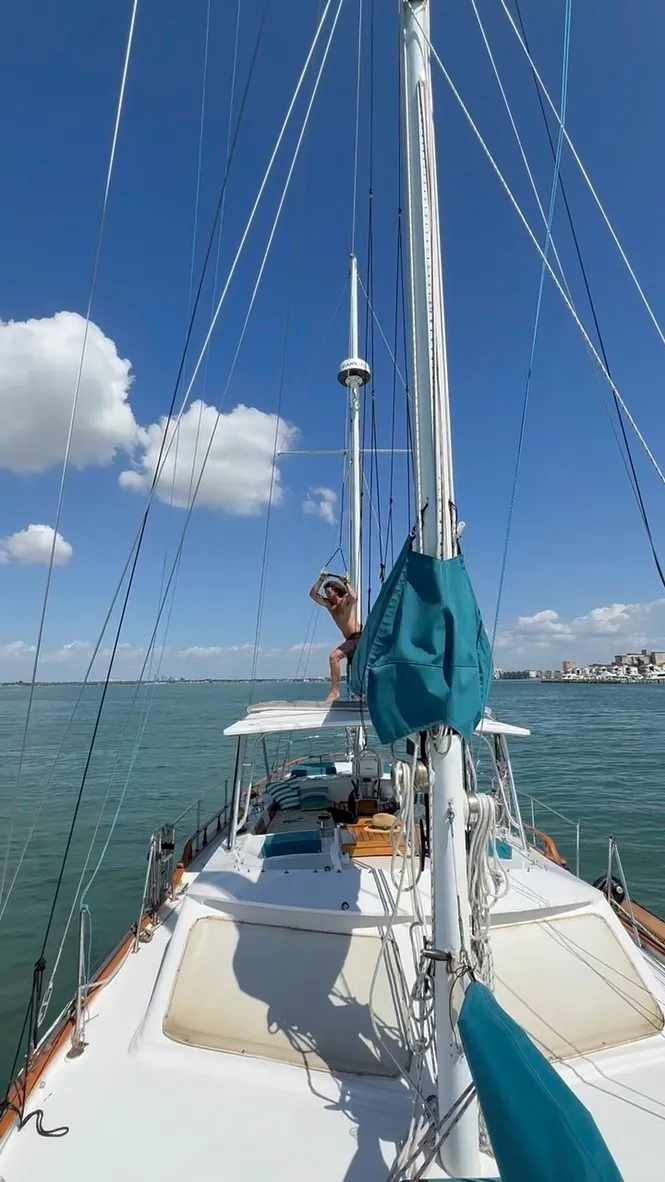 Guest on a rope swing from the deck of SV Cay Michele