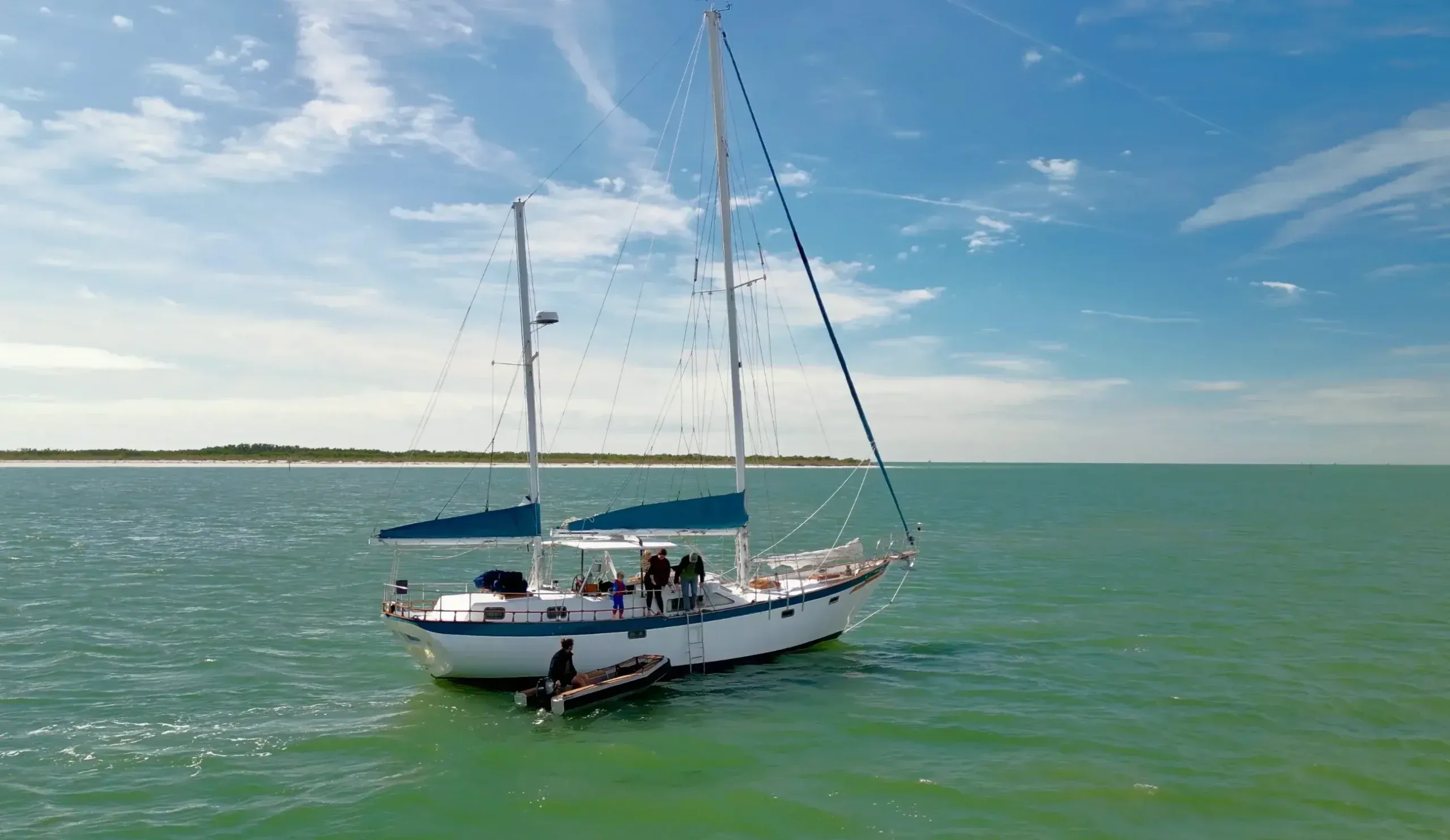 Aerial view of SV Cay Michele anchored near a barrier island